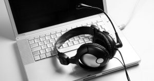 black and white of headphones on a laptop